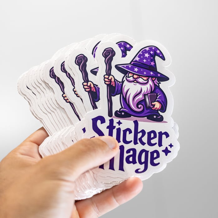 A hand holding a stack of StickerMage wizard stickers